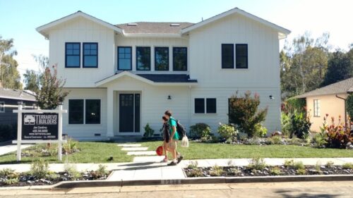 1238 Clark House with kids walking out front after remodel