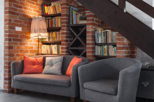 Bookshelf and study area below stairs