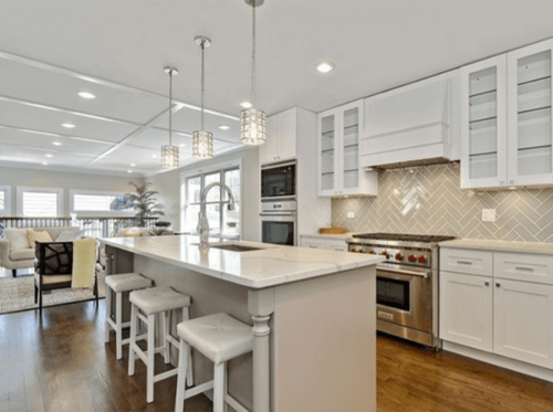 1922 Fletcher remodeled white kitchen with beautiful lighting, gas stove, bar stools and large open concept