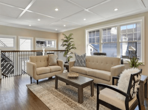 Fletcher living room with large windows, bright lights and cream furniture