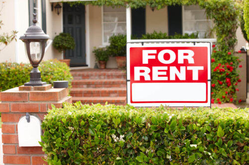 Red For Rent Sign on front lawn of house