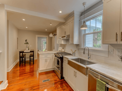 Kitchen and dining room with bright lighting and wood floors