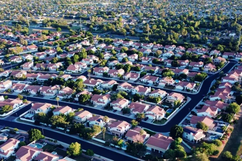 Aerial view of a neighborhood with red roofs and trees