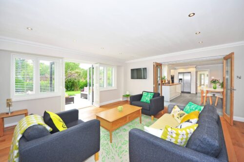 Wide open living room leading into kitchen and outdoor patio