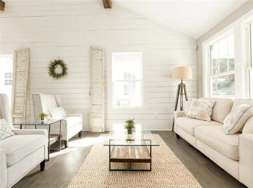 Modern living room with cream furniture, shiplap and simple decoration