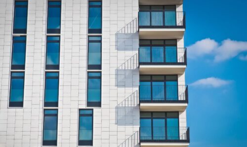 Modern apartment building with porches and blue sky