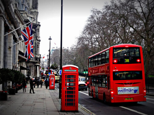 London double decker bus and telephone booth on busy street