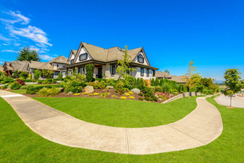 Row of large houses with winding sidewalk and beautiful landscaping