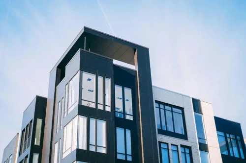 An upward view of a warrantable condo with clear blue sky in the background