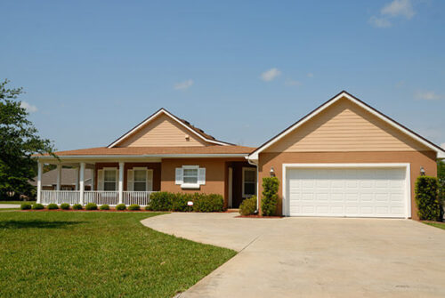 House with wrap around porch, large garage and wide driveway